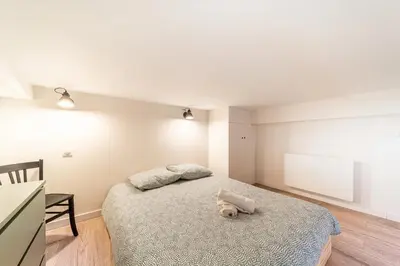 Un ou plusieurs lits dans un hébergement de l'établissement Smartstay - Suites Opera