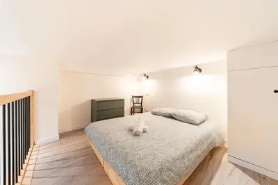 Un ou plusieurs lits dans un hébergement de l'établissement Smartstay - Suites Opera
