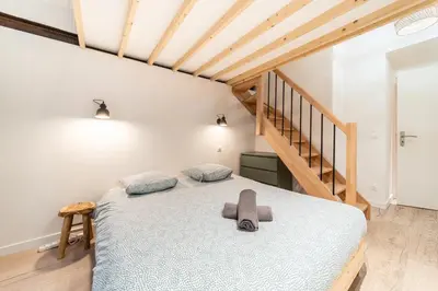 Un ou plusieurs lits dans un hébergement de l'établissement Smartstay - Suites Opera
