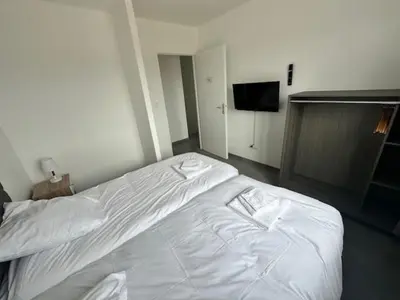 Un ou plusieurs lits dans un hébergement de l'établissement MAISON 60 avec 3 chambres lechaffardcom
