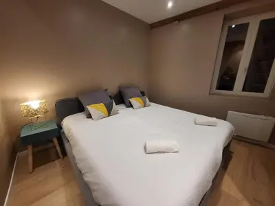 Un ou plusieurs lits dans un hébergement de l'établissement New Bocuse appartement