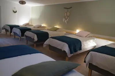 Un ou plusieurs lits dans un hébergement de l'établissement Clos du Régrillon