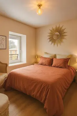 Un ou plusieurs lits dans un hébergement de l'établissement Charmant appartement cosy, tout équipé à Charbonnières