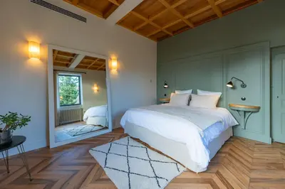 Un ou plusieurs lits dans un hébergement de l'établissement La Maison et l'Orangerie