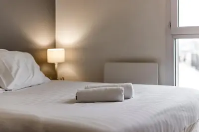 Un ou plusieurs lits dans un hébergement de l'établissement Appartement lumineux Charpennes 2 chambres+ Balcon
