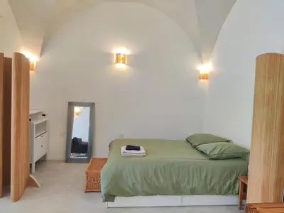 Un ou plusieurs lits dans un hébergement de l'établissement L'écurie du Château - Suite voûtée d'exception