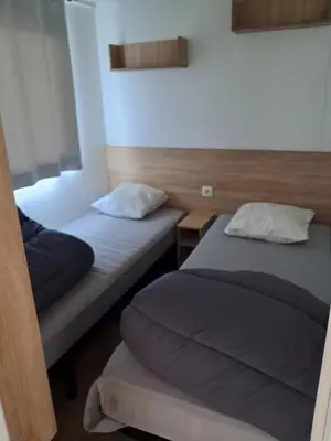 Un ou plusieurs lits dans un hébergement de l'établissement Camping du moulin