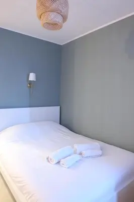 Un ou plusieurs lits dans un hébergement de l'établissement Studio avec parking privé à 8 min du tram