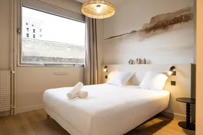 Un ou plusieurs lits dans un hébergement de l'établissement Le Confluence - Cocooning City Lyon