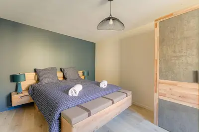 Un ou plusieurs lits dans un hébergement de l'établissement Legend, appartement confort premium, idéal pour séjour professionnel