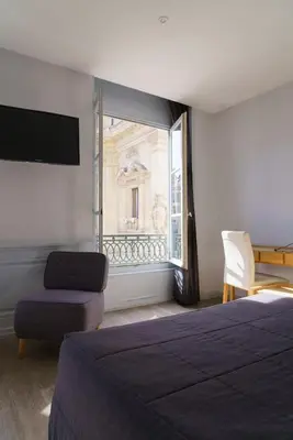 Un ou plusieurs lits dans un hébergement de l'établissement Hotel du Théatre