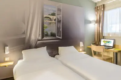 Un ou plusieurs lits dans un hébergement de l'établissement B&B HOTEL Lyon St Priest