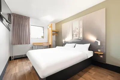 Un ou plusieurs lits dans un hébergement de l'établissement B&B HOTEL Lyon Centre Monplaisir