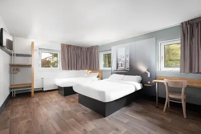 Un ou plusieurs lits dans un hébergement de l'établissement B&B HOTEL Lyon Centre Monplaisir