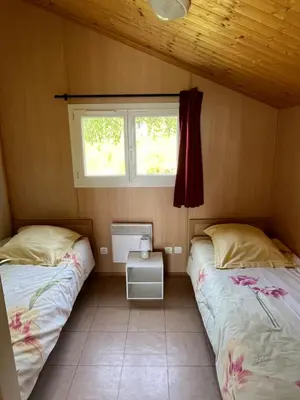 Un ou plusieurs lits dans un hébergement de l'établissement Les Chalets du Piou