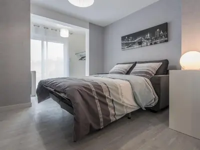 Un ou plusieurs lits dans un hébergement de l'établissement Appart Hôtel Bourgoin