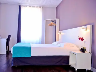 Un ou plusieurs lits dans un hébergement de l'établissement Hotel Le Comty