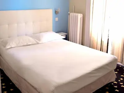 Un ou plusieurs lits dans un hébergement de l'établissement Hotel Le Comty