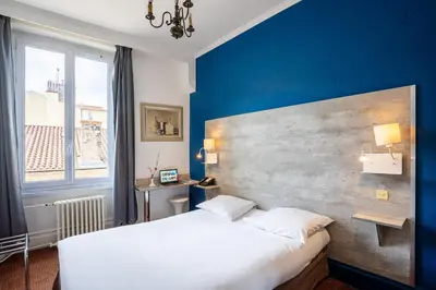 Un ou plusieurs lits dans un hébergement de l'établissement Hôtel du Helder