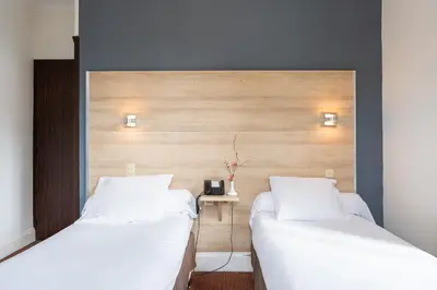 Un ou plusieurs lits dans un hébergement de l'établissement Hôtel du Helder