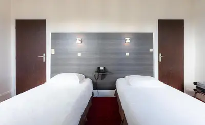 Un ou plusieurs lits dans un hébergement de l'établissement Hôtel du Helder