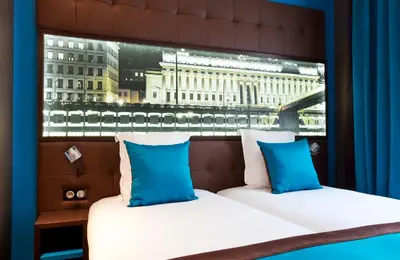 Un ou plusieurs lits dans un hébergement de l'établissement Hotel des Savoies Lyon Perrache