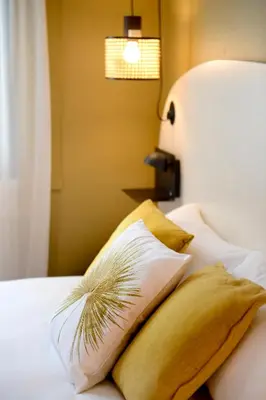 Un ou plusieurs lits dans un hébergement de l'établissement Hôtel Villa Berlioz