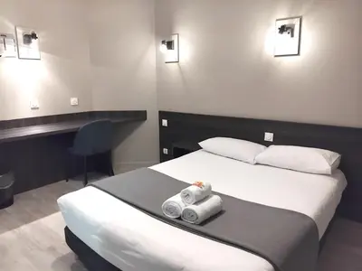 Un ou plusieurs lits dans un hébergement de l'établissement Hôtel Le Bratoria, anciennement Le Saint Vincent