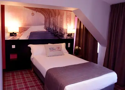 Un ou plusieurs lits dans un hébergement de l'établissement Hotel Victoria Lyon Perrache Confluence