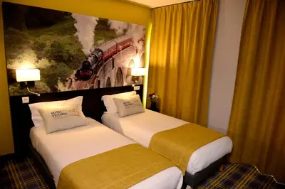 Un ou plusieurs lits dans un hébergement de l'établissement Hotel Victoria Lyon Perrache Confluence