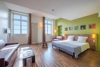 Un ou plusieurs lits dans un hébergement de l'établissement Appart Hôtel Belambra Lyon Villemanzy