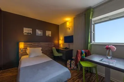 Un ou plusieurs lits dans un hébergement de l'établissement Appart Hôtel Belambra Lyon Villemanzy