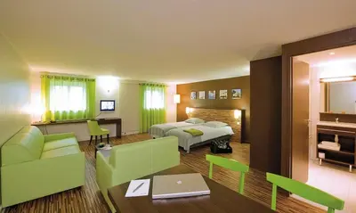 Un ou plusieurs lits dans un hébergement de l'établissement Appart Hôtel Belambra Lyon Villemanzy