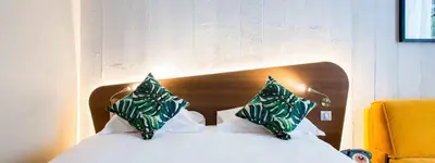 Un ou plusieurs lits dans un hébergement de l'établissement KOPSTER Hotel Lyon Groupama Stadium