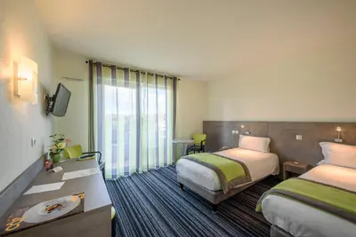 Un ou plusieurs lits dans un hébergement de l'établissement Hotel Le Chatard