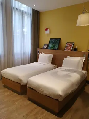 Un ou plusieurs lits dans un hébergement de l'établissement Maison Nô - Hôtel et Rooftop