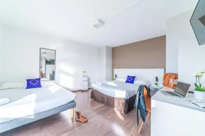 Un ou plusieurs lits dans un hébergement de l'établissement Résidence Montempô Appart'Hôtel Lyon Part Dieu