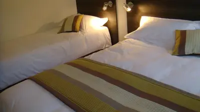 Un ou plusieurs lits dans un hébergement de l'établissement Côté Hôtel