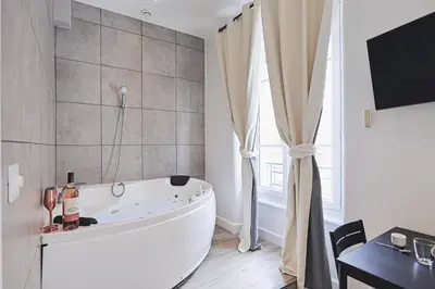 Télévision ou salle de divertissement dans l'établissement LES BULLES DE MONA - Zen - Spa - Clim