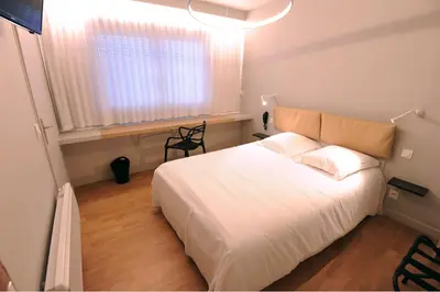 Un ou plusieurs lits dans un hébergement de l'établissement Hôtel Vulcain