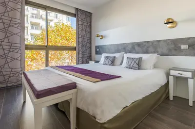 Un ou plusieurs lits dans un hébergement de l'établissement Lagrange Aparthotel Lyon Lumière