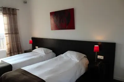 Un ou plusieurs lits dans un hébergement de l'établissement Hôtel Le Domaine des Vignes Ampuis Lyon Sud Vienne