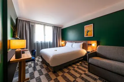 Un ou plusieurs lits dans un hébergement de l'établissement Hotel Le Lumière