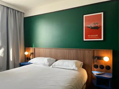 Un ou plusieurs lits dans un hébergement de l'établissement Hotel Le Lumière
