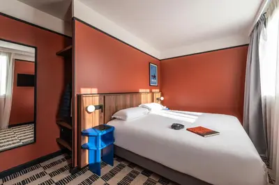 Un ou plusieurs lits dans un hébergement de l'établissement Hotel Le Lumière