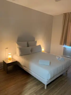 Un ou plusieurs lits dans un hébergement de l'établissement Hôtel Le Costellan