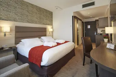 Un ou plusieurs lits dans un hébergement de l'établissement Kyriad Prestige Lyon Est - Saint Priest Eurexpo Hotel and SPA