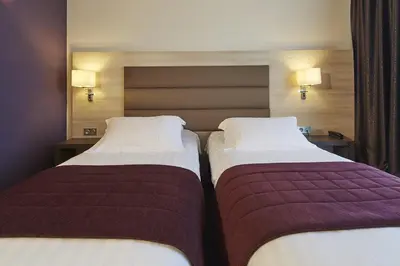 Un ou plusieurs lits dans un hébergement de l'établissement Kyriad Prestige Lyon Est - Saint Priest Eurexpo Hotel and SPA