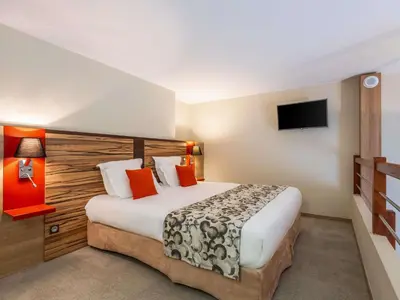 Un ou plusieurs lits dans un hébergement de l'établissement Aparthotel Adagio Lyon Patio Confluence