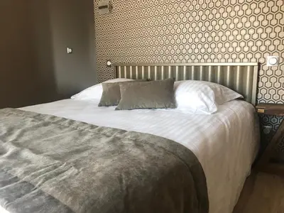 Un ou plusieurs lits dans un hébergement de l'établissement La Maison du Faisan Doré